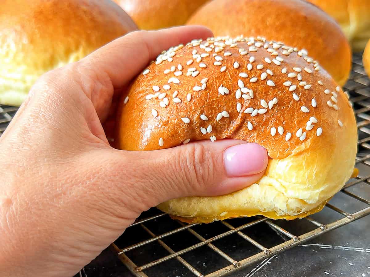 Squeezing a hamburger bun.