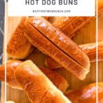 Pinterest image of Hot dog buns on a wooden cutting board.