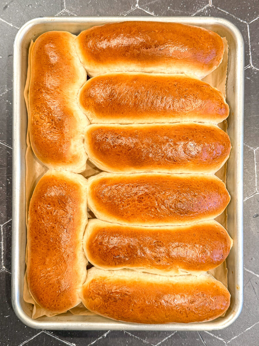 Hot dog buns on a sheet pan.