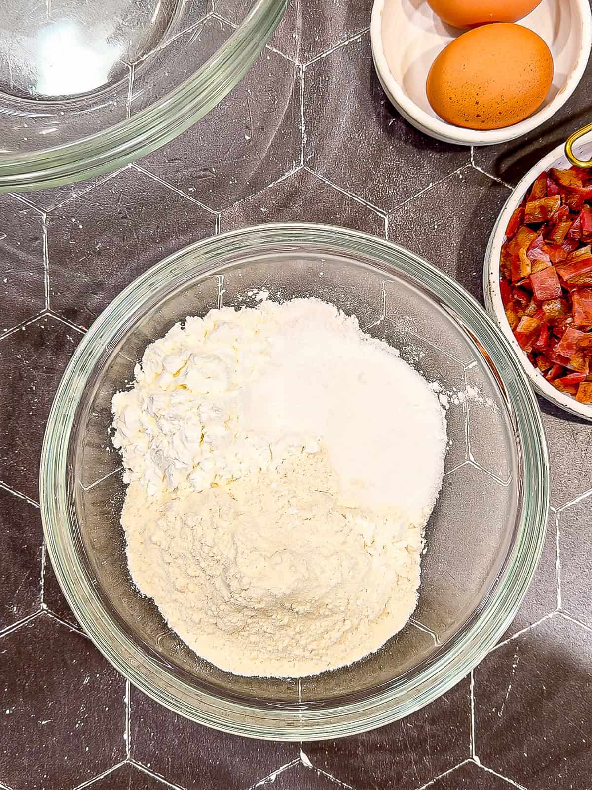 Dry ingredients for waffles in a glass bowl.