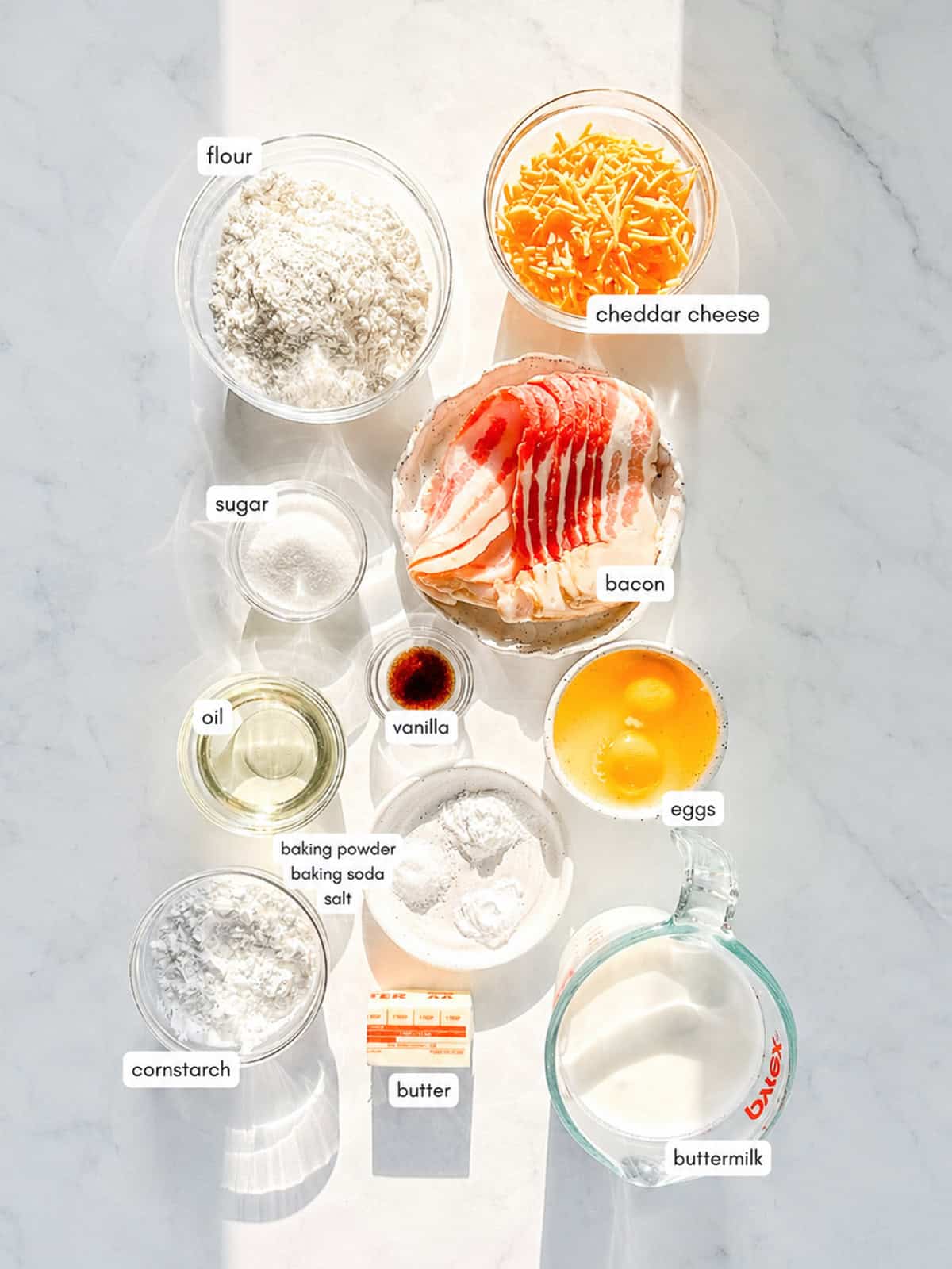 Labeled image of ingredients needed to make bacon and cheddar waffles.
