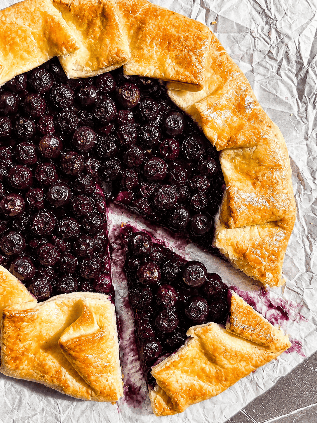 Blueberry galette on parchment paper.