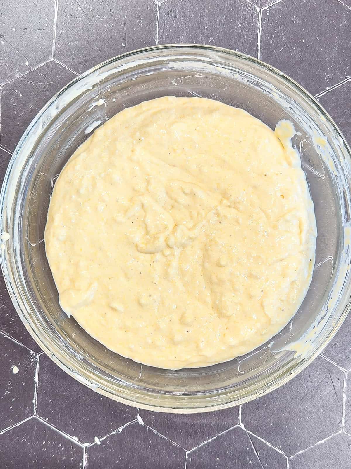 Waffle batter in a glass bowl.