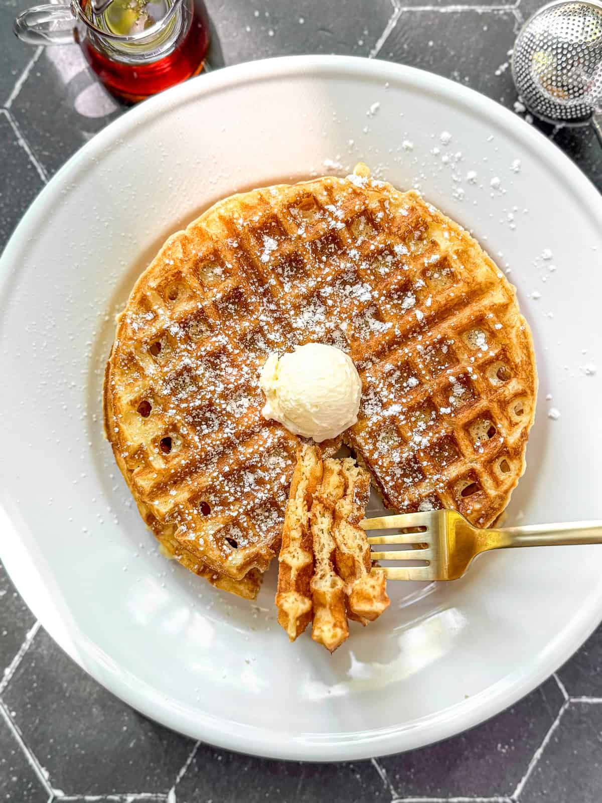 Cornmeal waffles on a white plate.