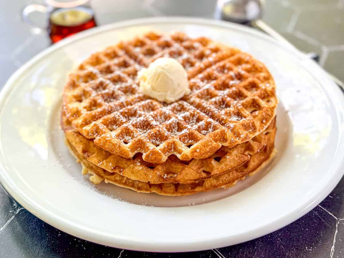 Cornmeal waffles on a white plate.