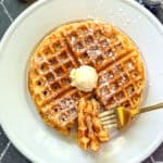 Cornmeal waffles on a white plate.
