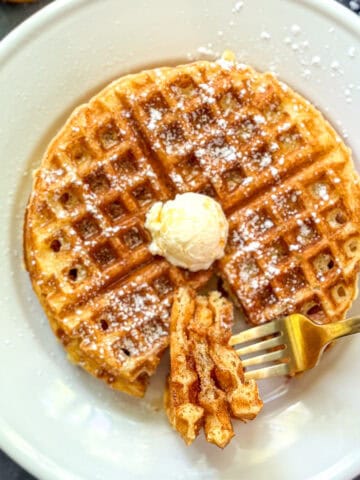 Cornmeal waffles on a white plate.