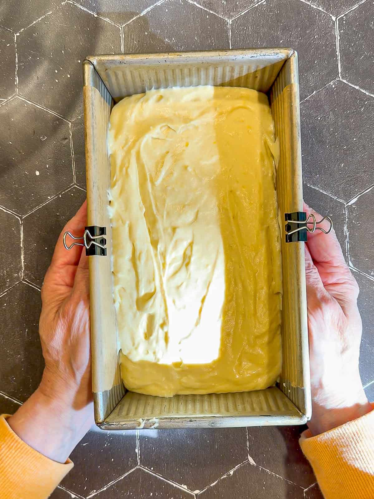 Lemon loaf cake batter in a loaf pan.
