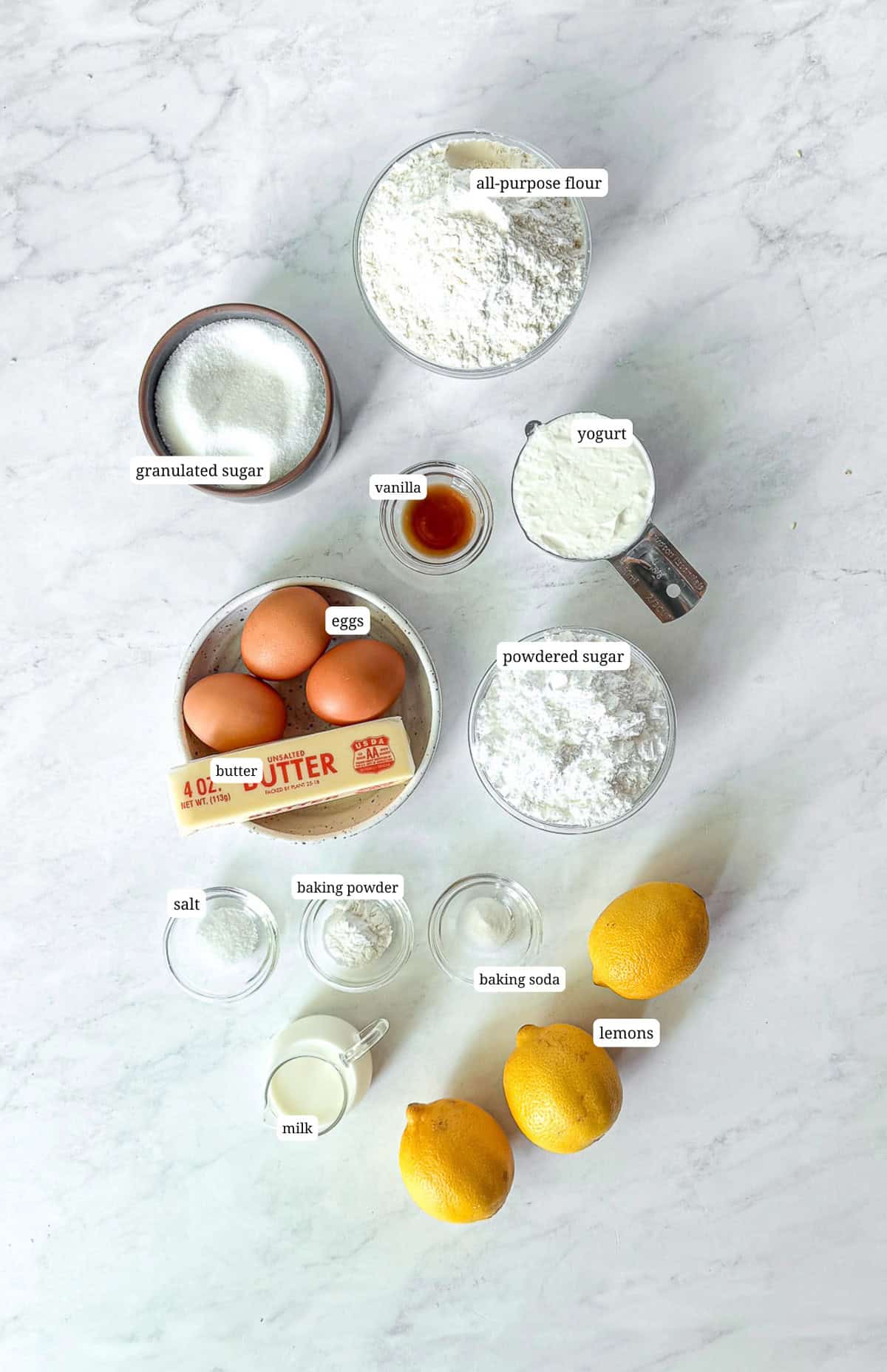 Ingredients needed to make a lemon loaf cake with lemon glaze.