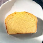 A slice of lemon loaf cake on a white plate.