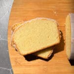 Slices of lemon loaf cake on a wooden cutting board.