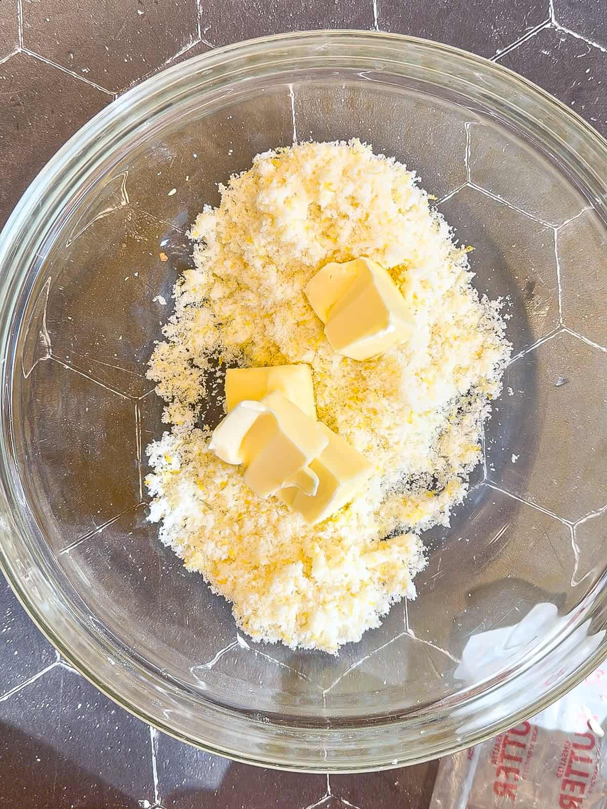 Lemon sugar and softened butter in a glass bowl.