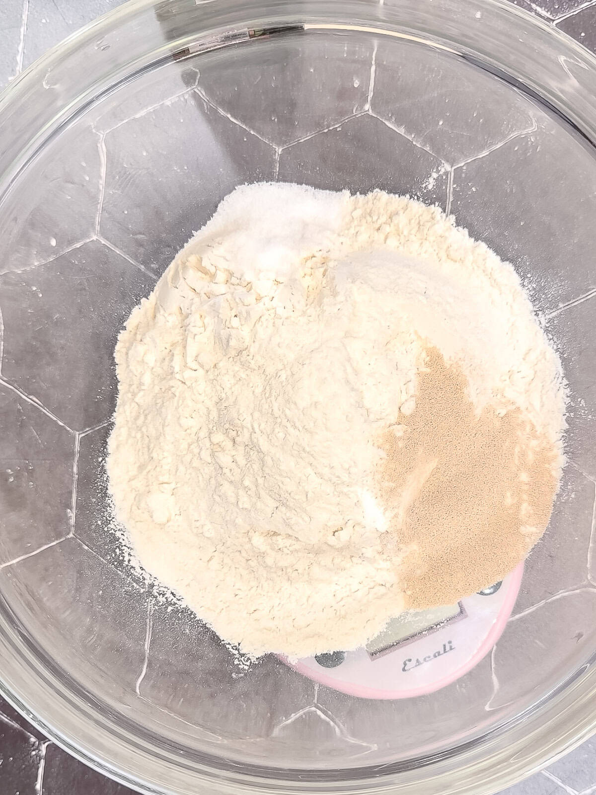 Flower, instant yeast, and salt in a glass bowl.