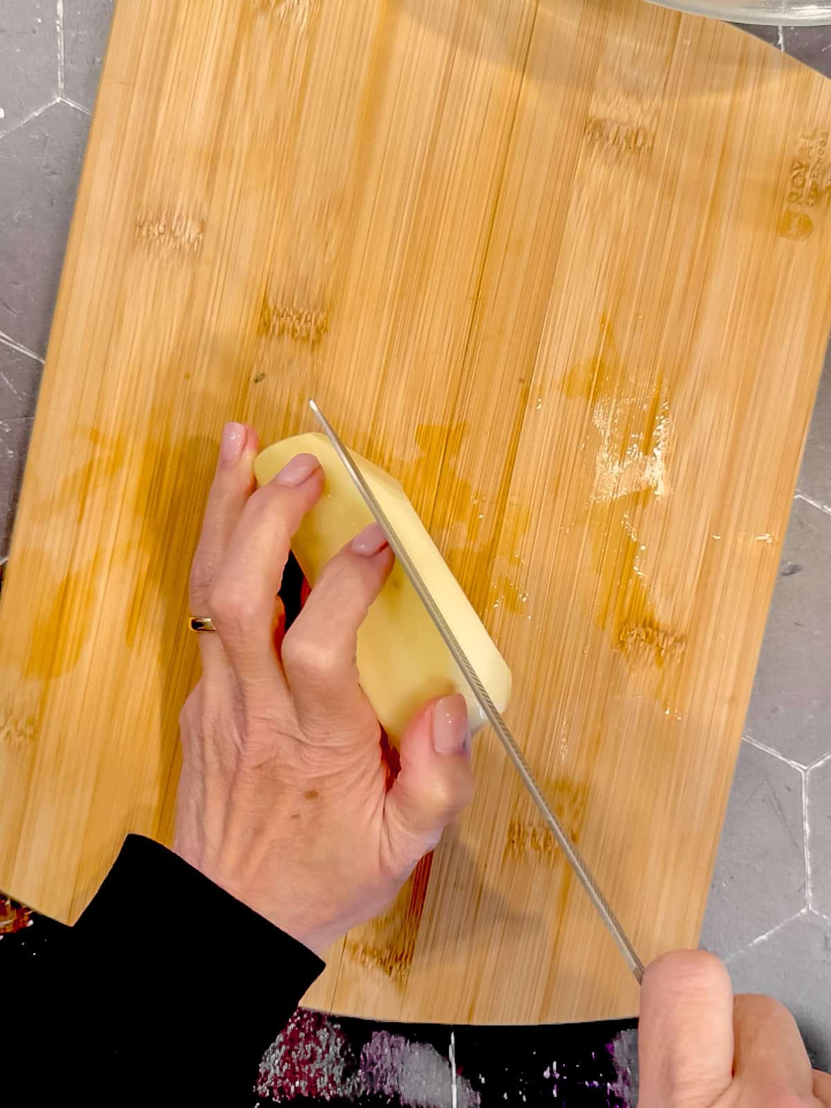 Cutting a potato into a quarter inch planks.