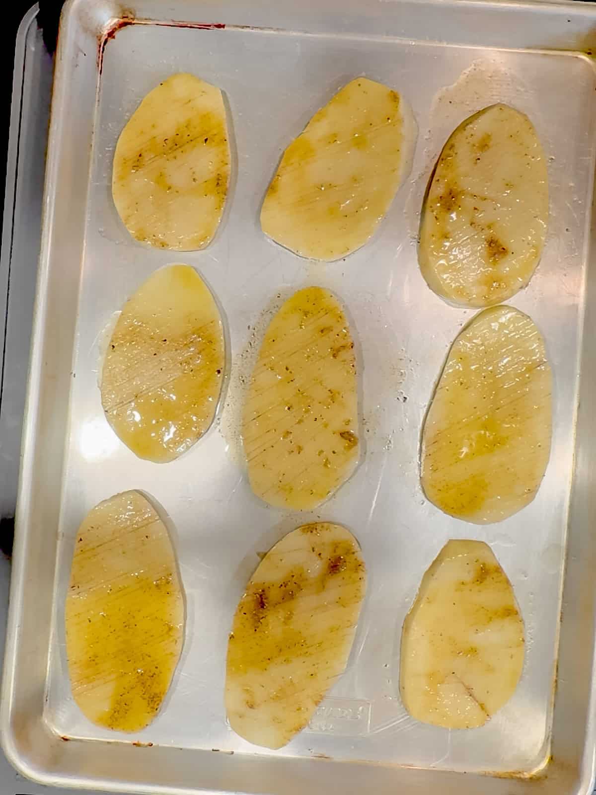 Accordion potatoes on a sheet pan ready to go into the oven.