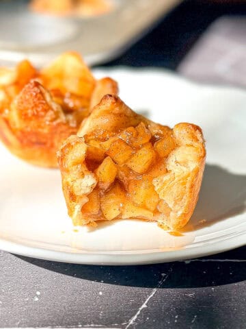 Baked apple croissants on a white plate.