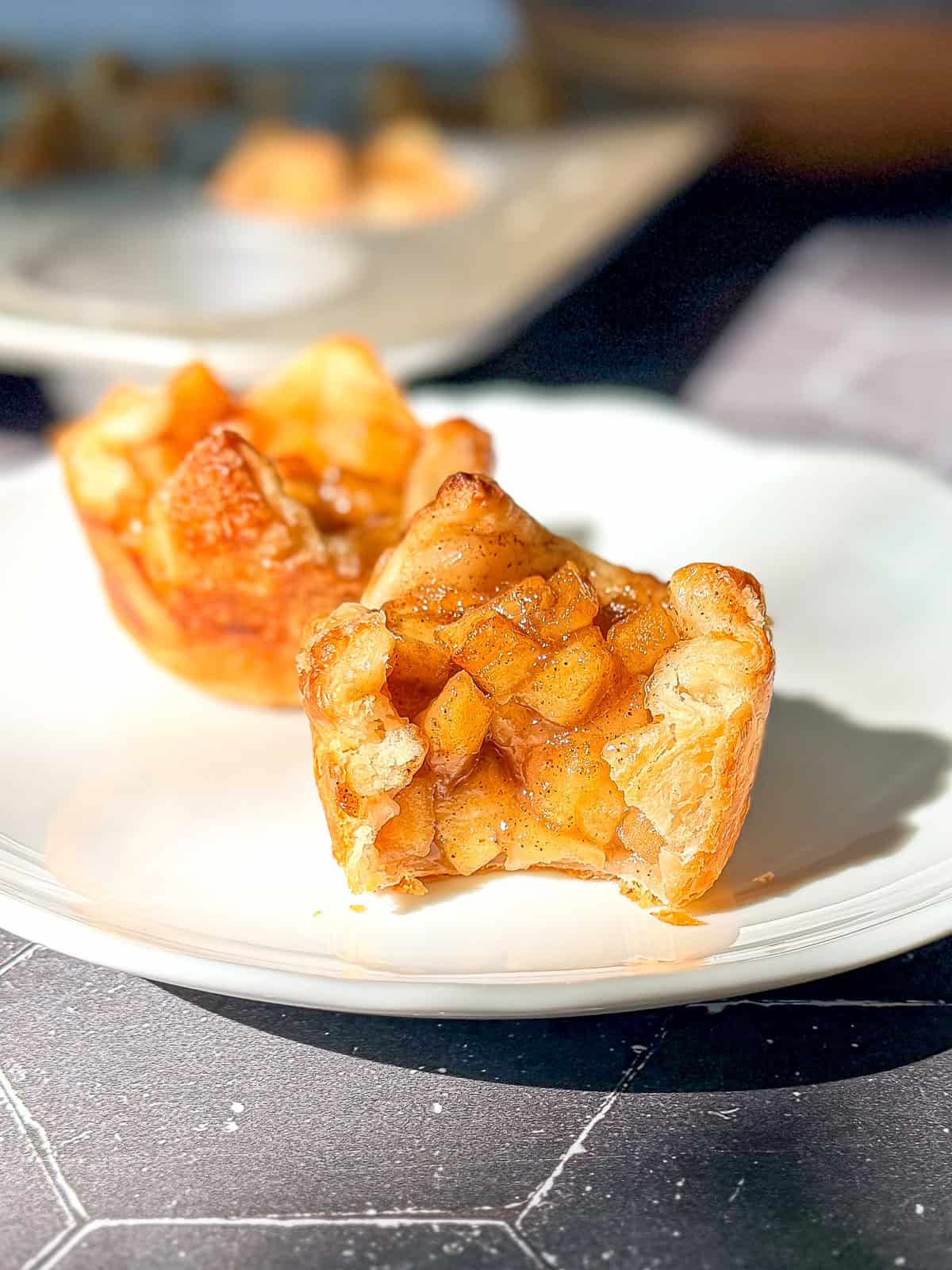 Baked apple croissants on a white plate.
