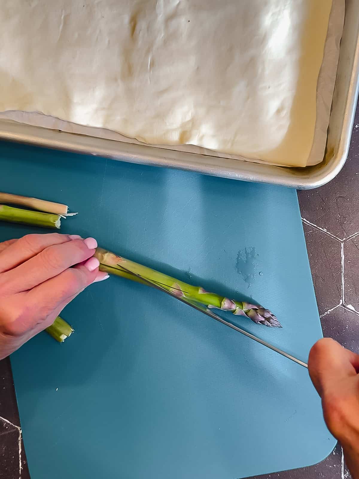 Slicing asparagus spears in half.