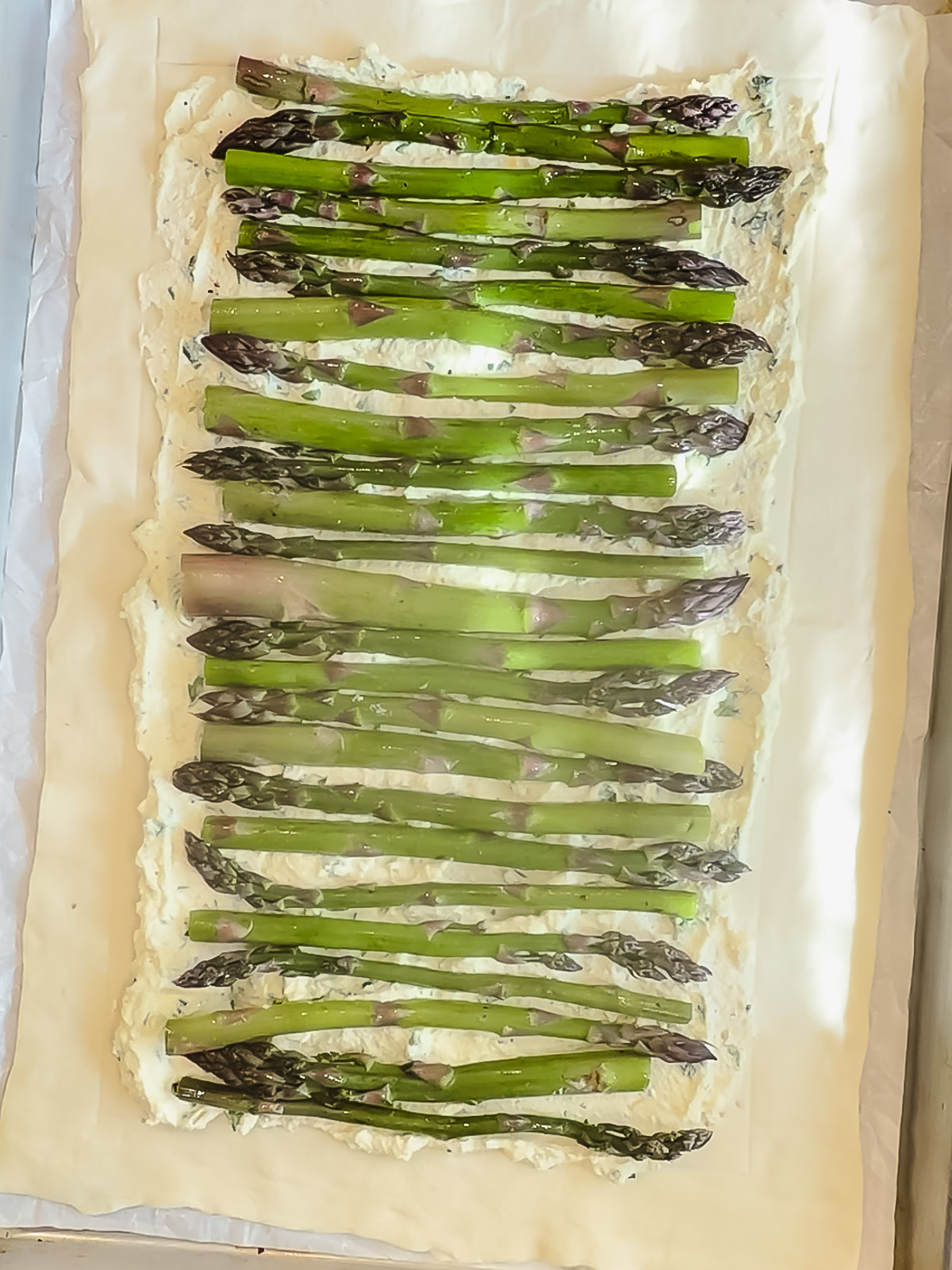 Asparagus and ricotta filling on top of puff pastry.