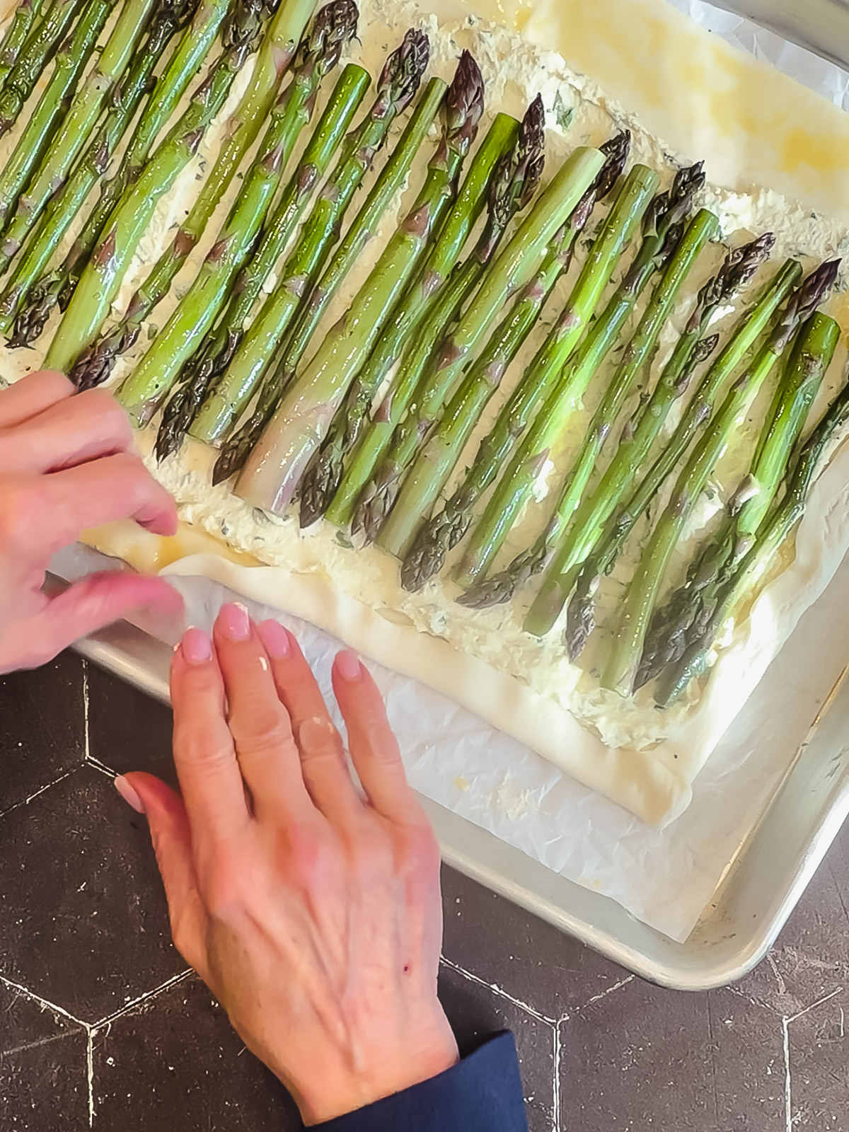 Folding up the edges of puff pastry to make a tart.