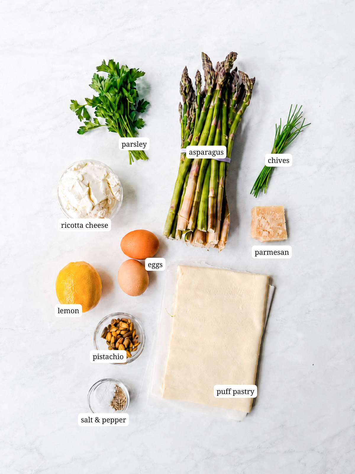 Ingredients needed to make an asparagus puff pastry tart.