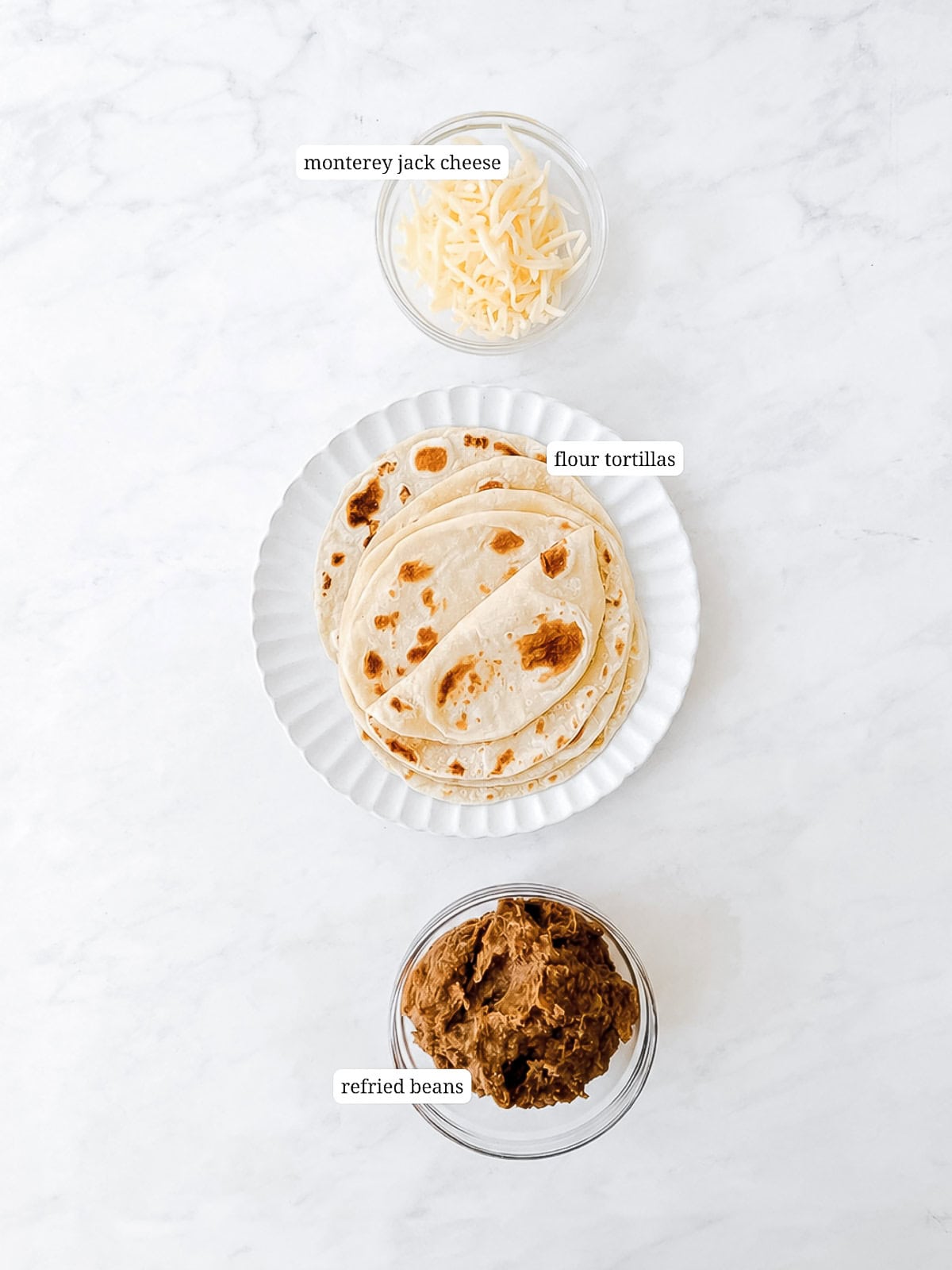 Ingredients needed to make bean and cheese tacos.