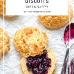 Pinterest image of Cornbread biscuits and a pot of jam with a spoon on parchment paper.
