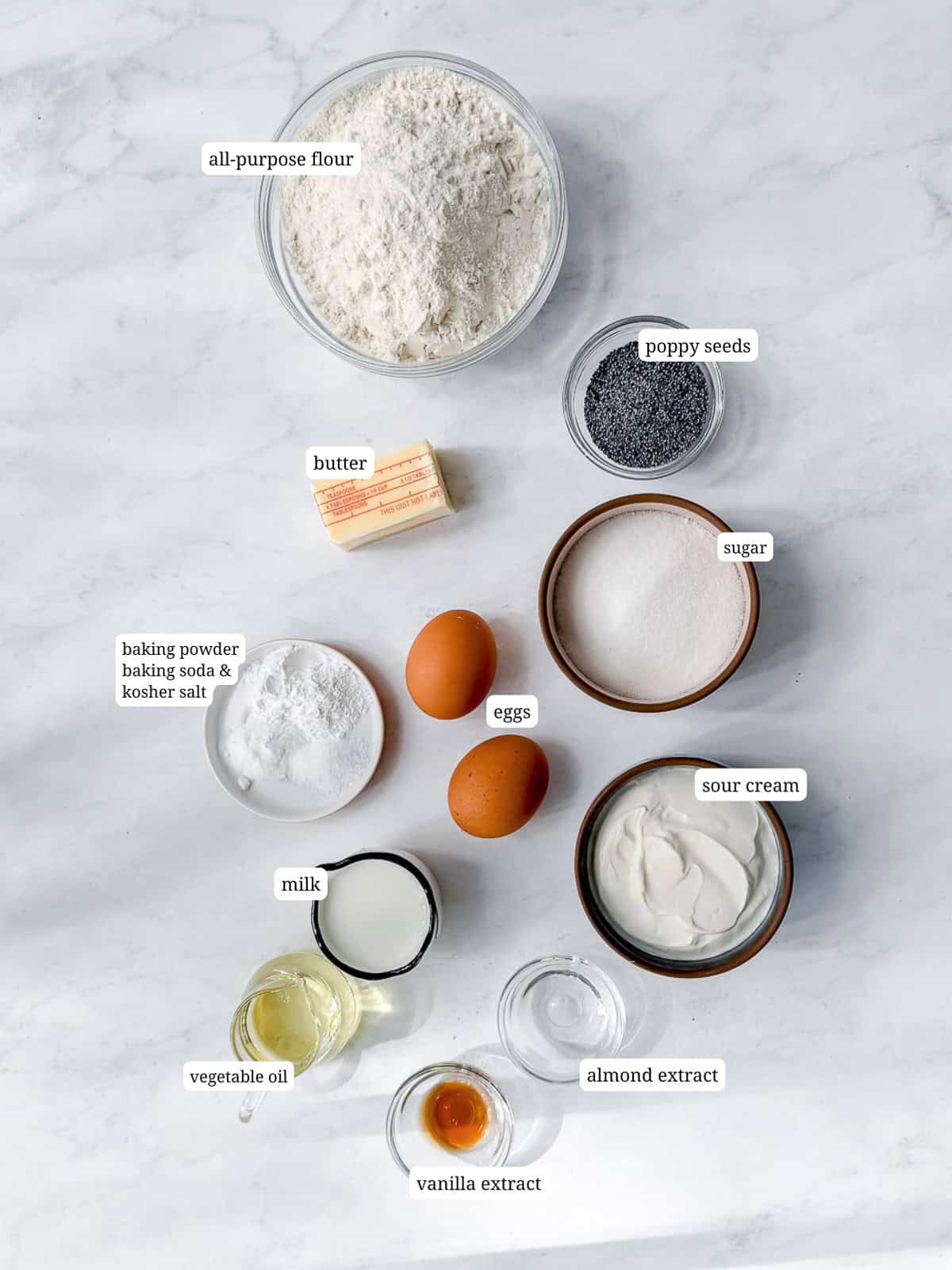 Ingredients needed to make almond poppy seed muffins.