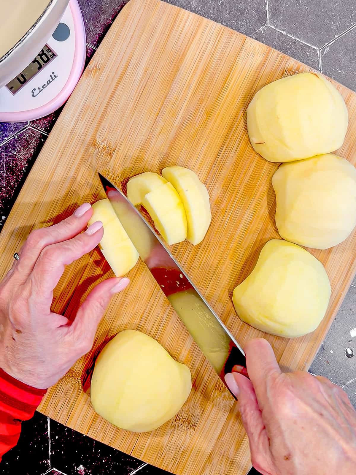 Cutting apples on a wooden cutting board.