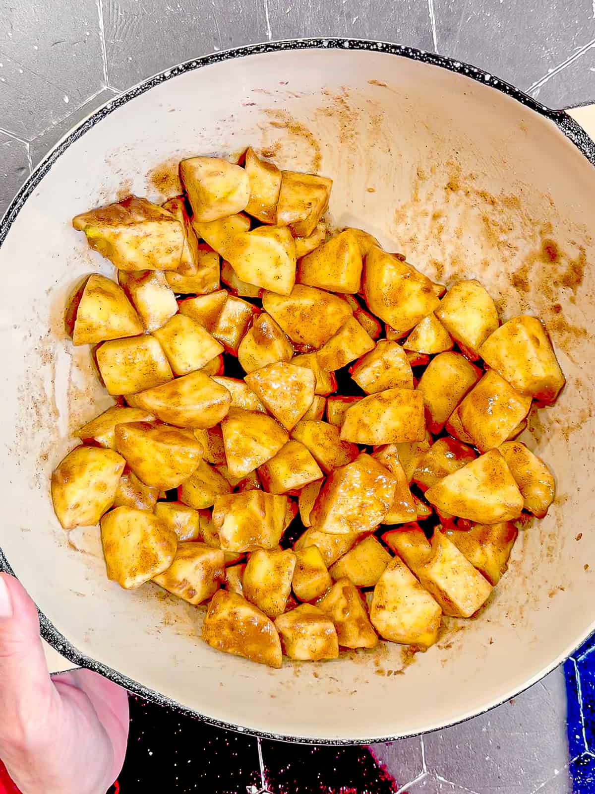 Spiced apple apples in a tan bowl with a black rim.
