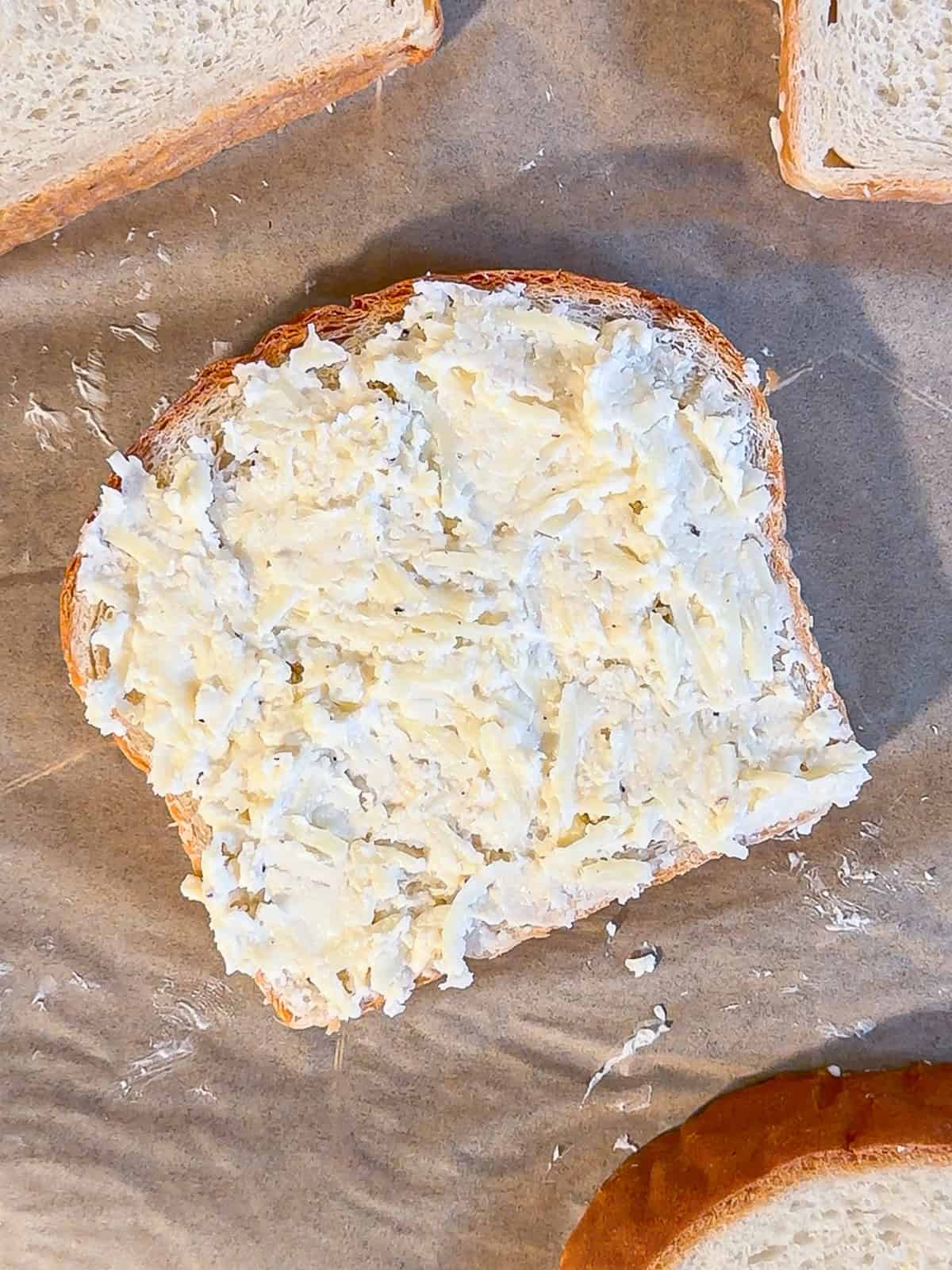 Cheese mixture spread on a piece of bread.