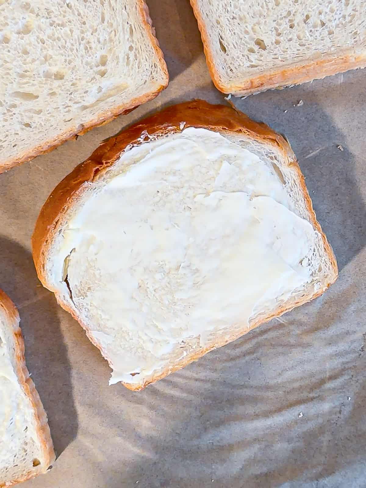 Butter spread on a piece of bread.