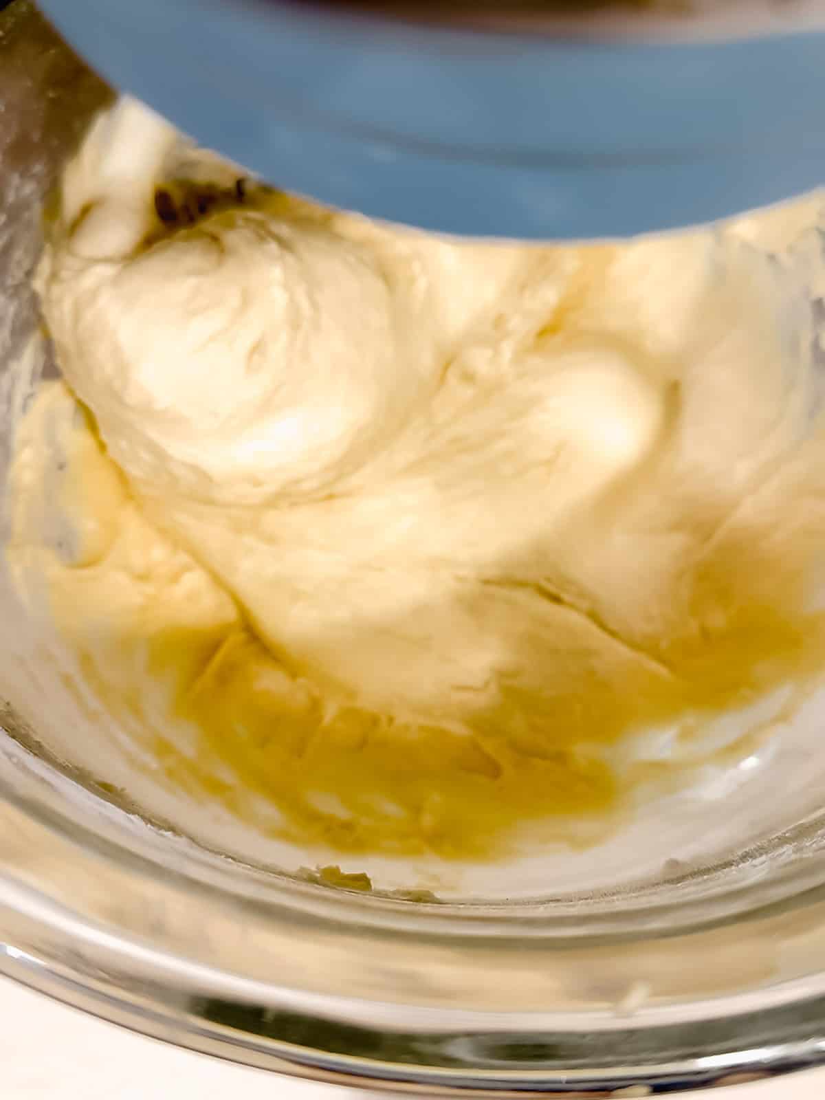 Mixing doughnut dough in a stand mixer with a dough hook.