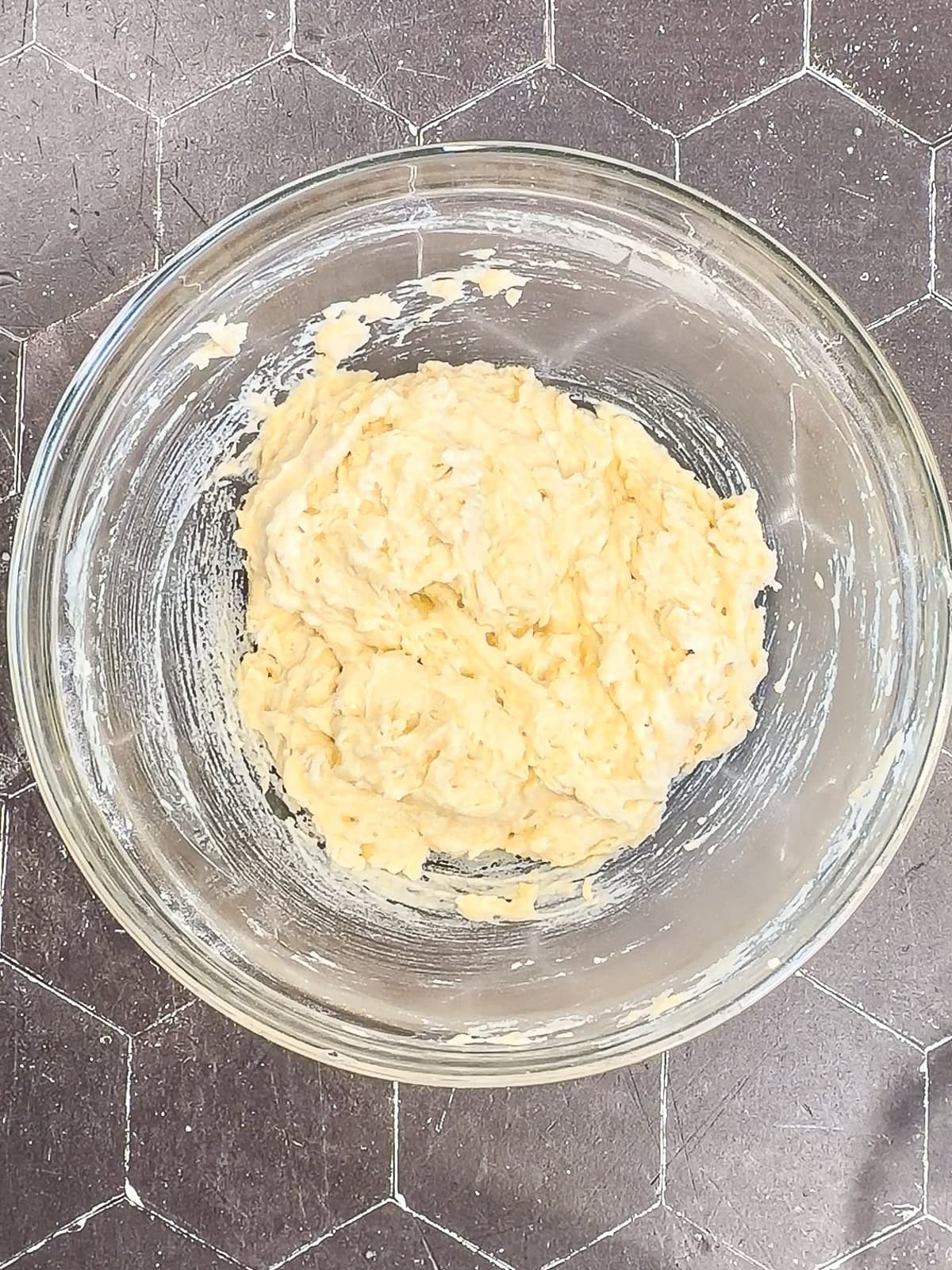 Fritter batter in a glass bowl.
