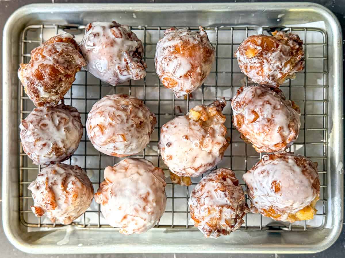 Apple fritters on a wire rack.