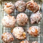 Apple fritters on a wire rack.