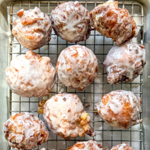Apple fritters on a wire rack.
