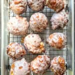Apple fritters on a wire rack.