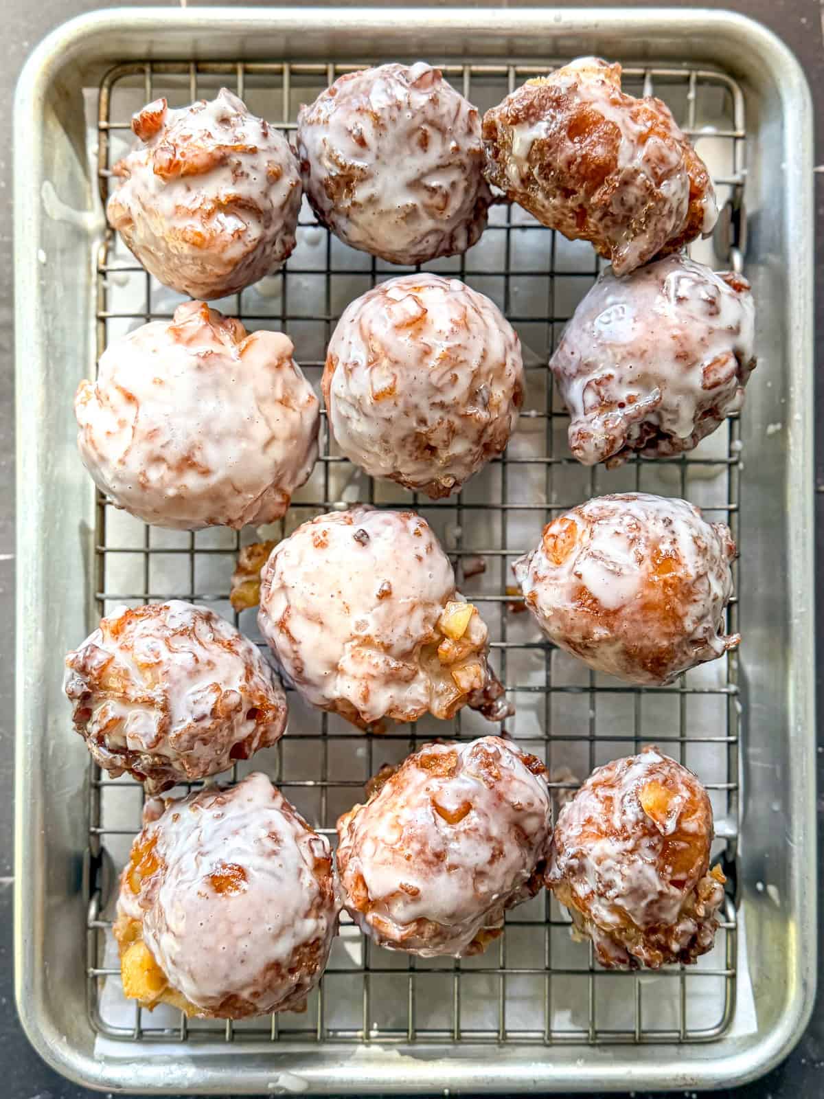Apple fritters on a wire rack.
