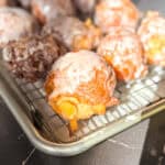 Apple fritters on a wire rack.