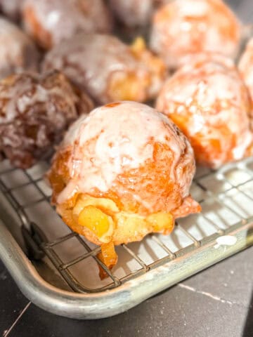 Apple fritters on a wire rack.