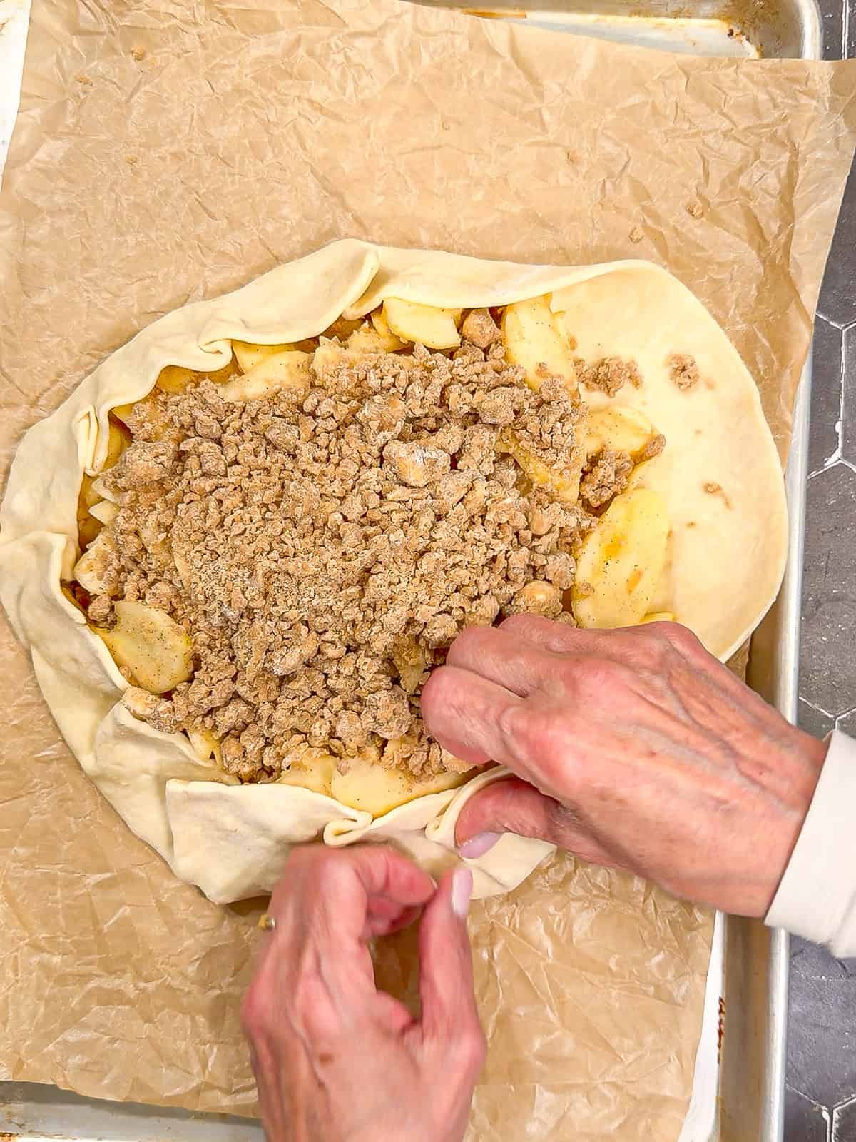 Folding up the crust for an apple streusel Gillett.