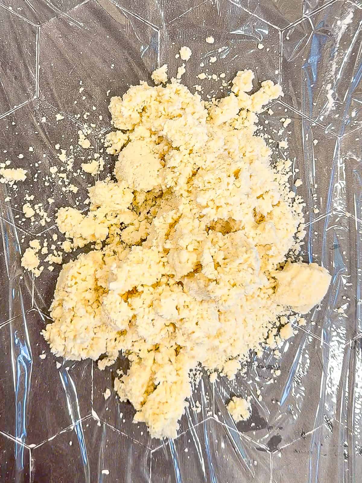 Crumbled pie crust, on a piece of plastic.
